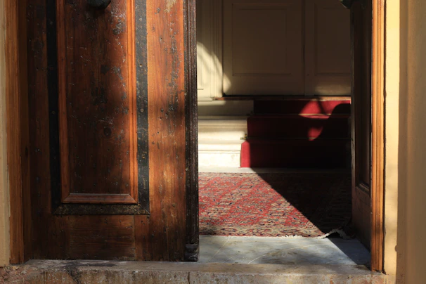 A bright, inviting doorway of a Delhi house featuring a freshly cleaned carpet and welcoming ambiance.