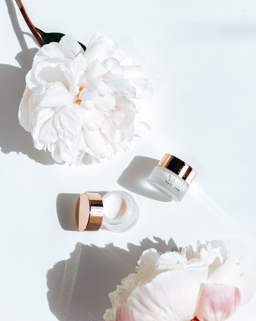 Petal Eye Cream, petite jars with rose-gold caps beside white peony petals