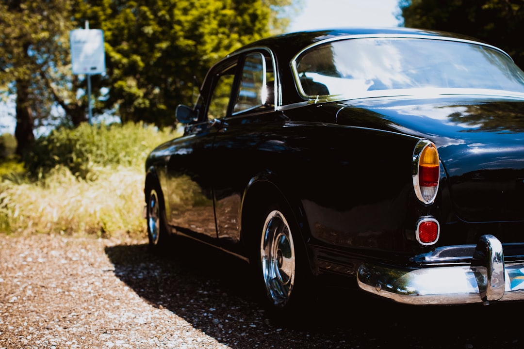 black sedan on brown grass field during daytime