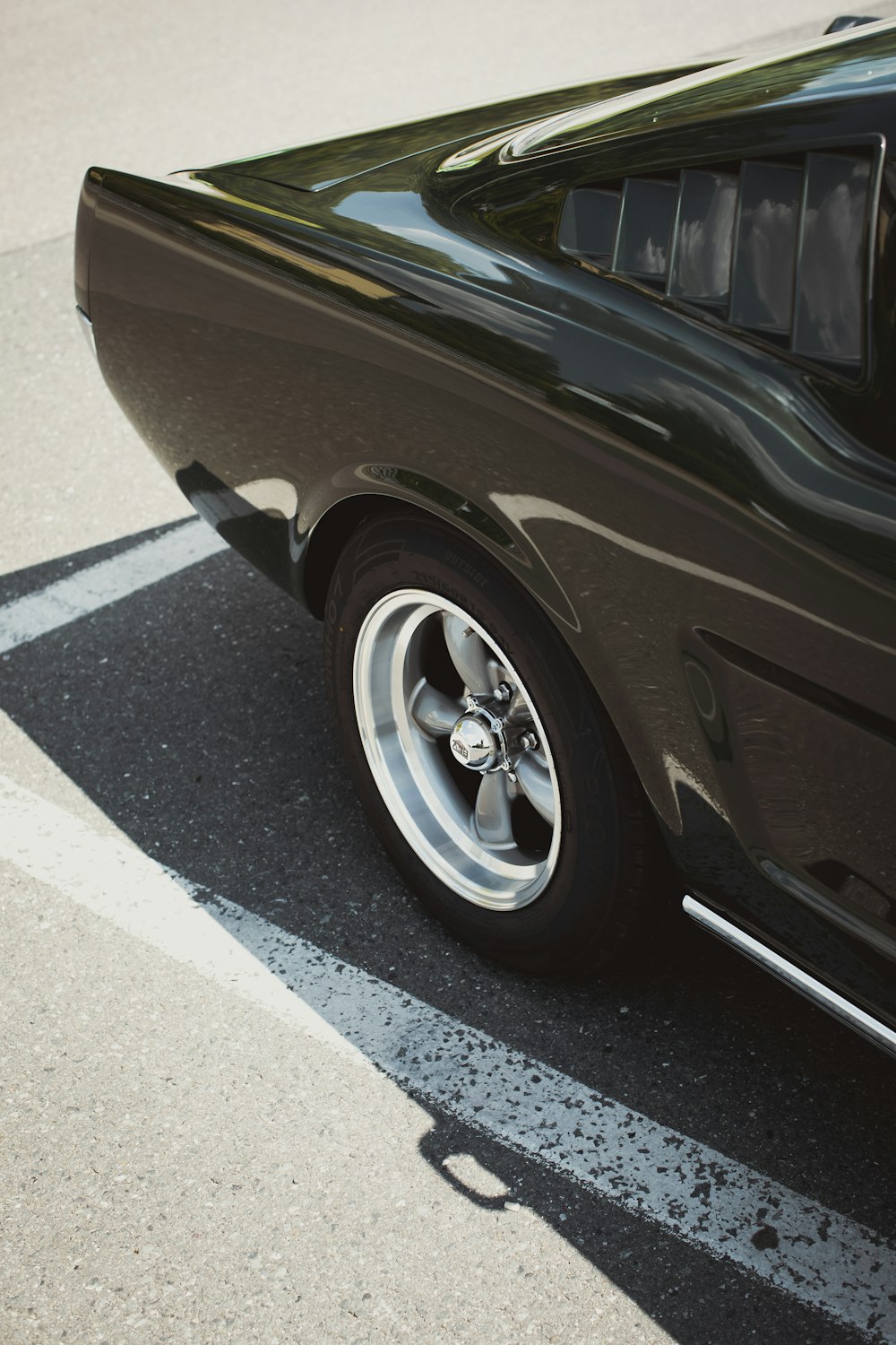 black car on gray asphalt road during daytime