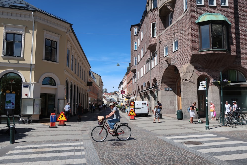 people walking on sidewalk near buildings during daytime