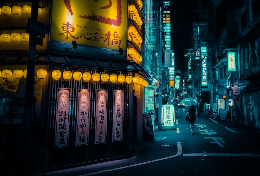 people walking on sidewalk during night time