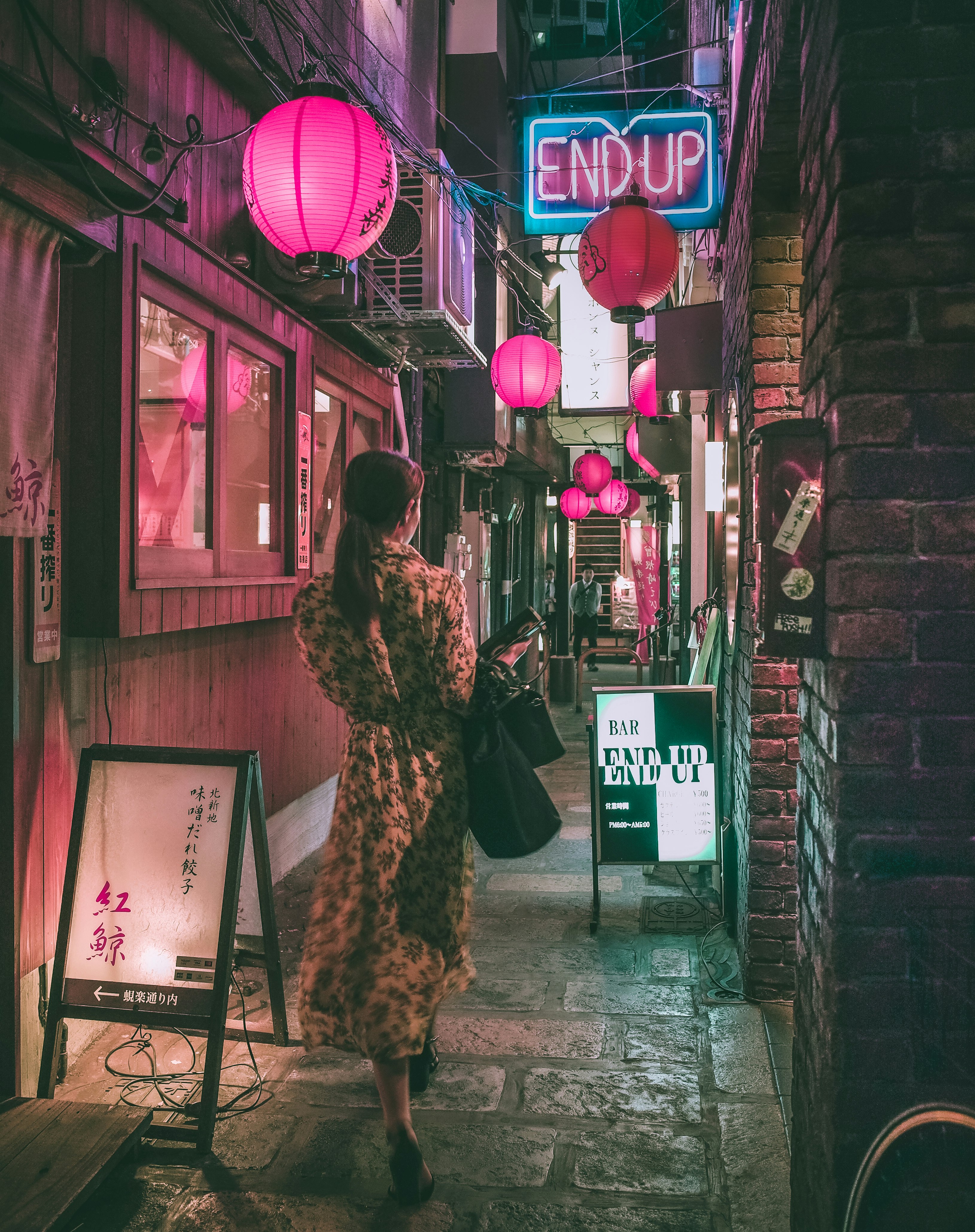 woman in brown and black leopard print coat standing beside store during night time