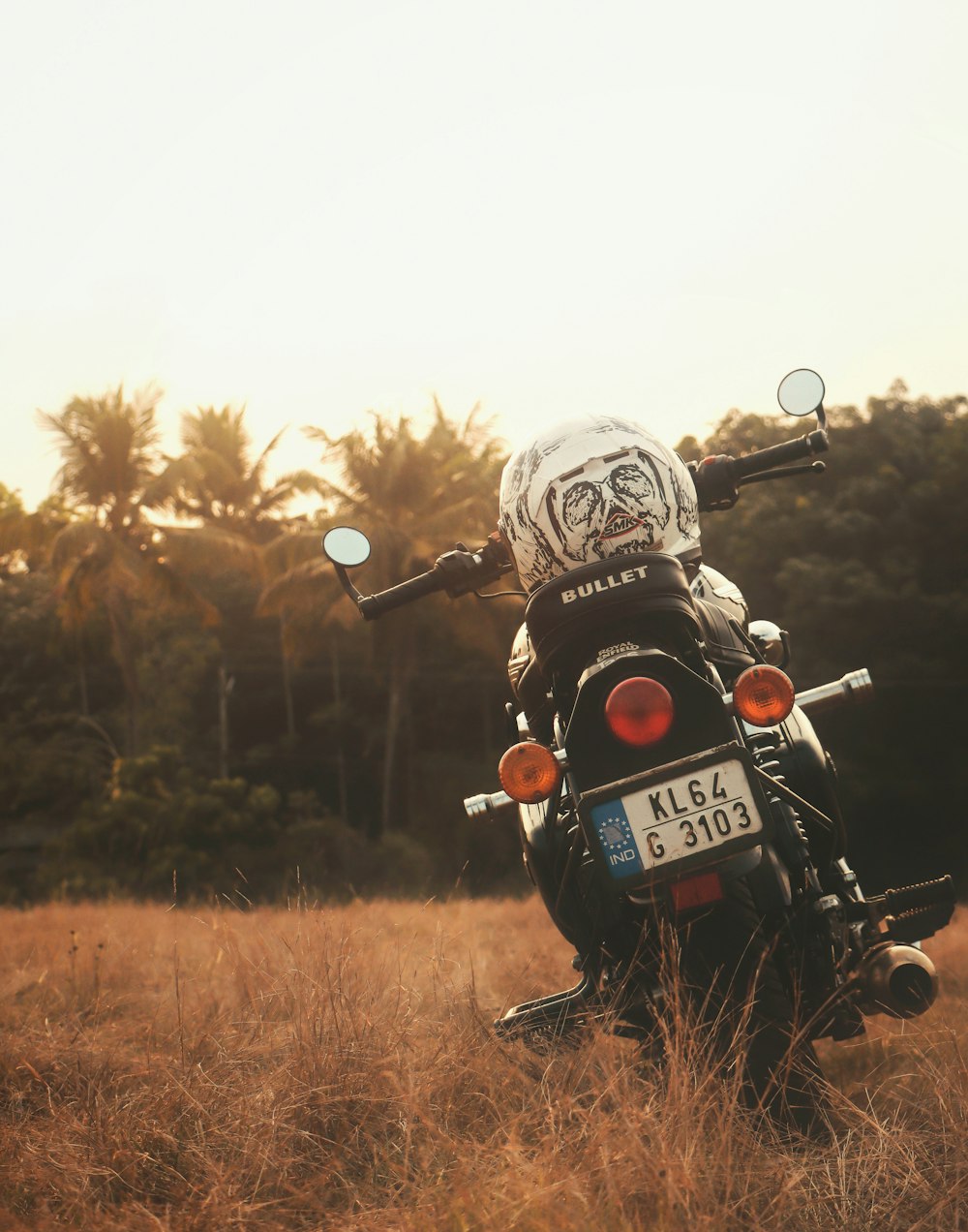 black and red motorcycle on brown grass field during daytime