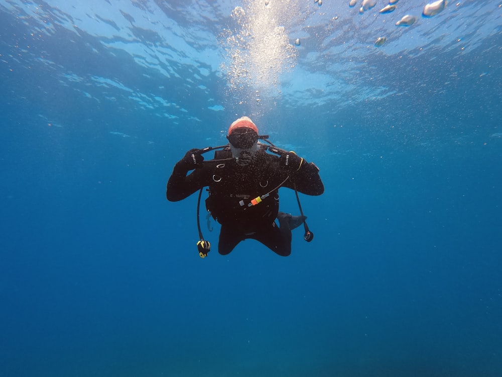 person in black wetsuit in water