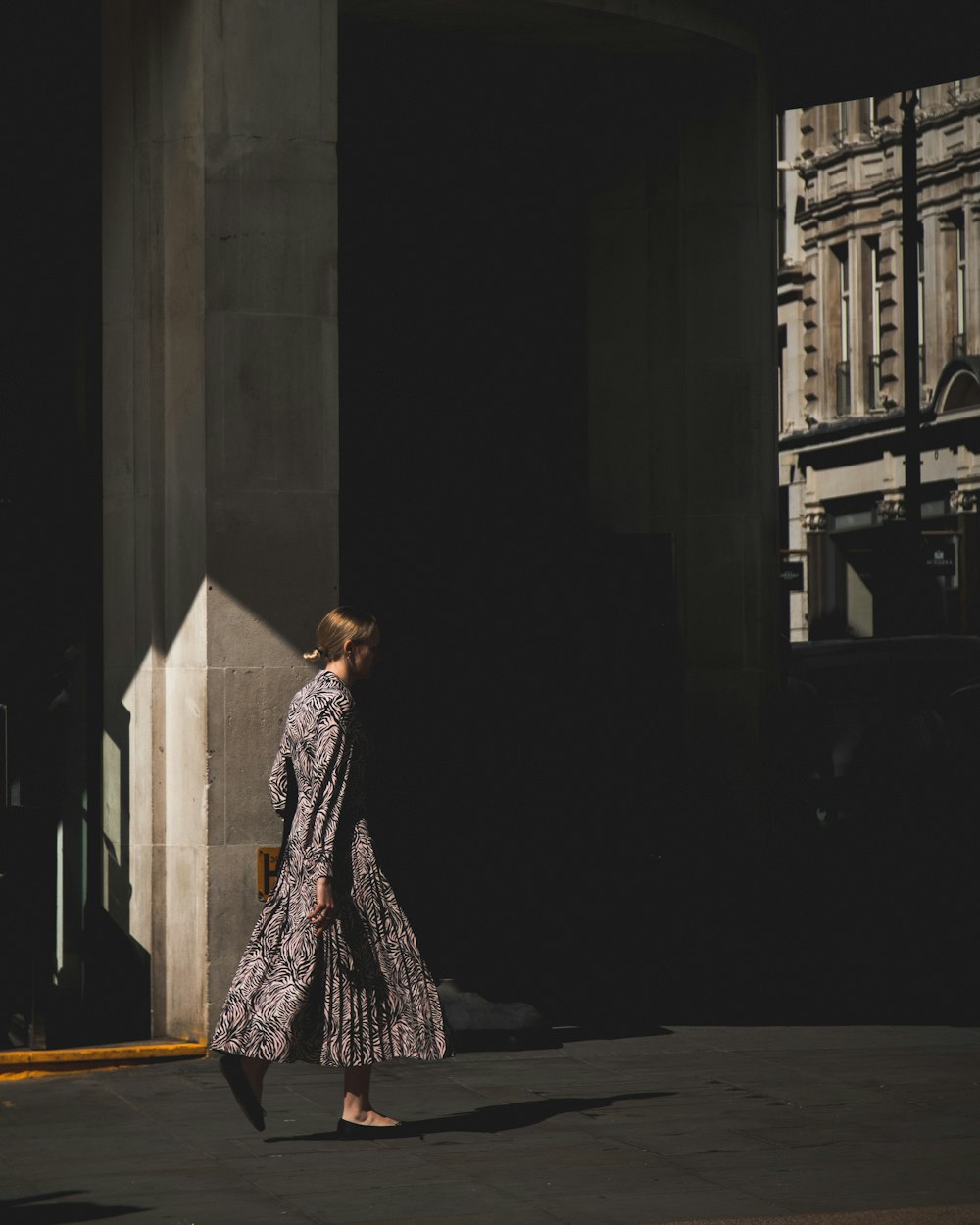 woman in purple and white dress standing on hallway