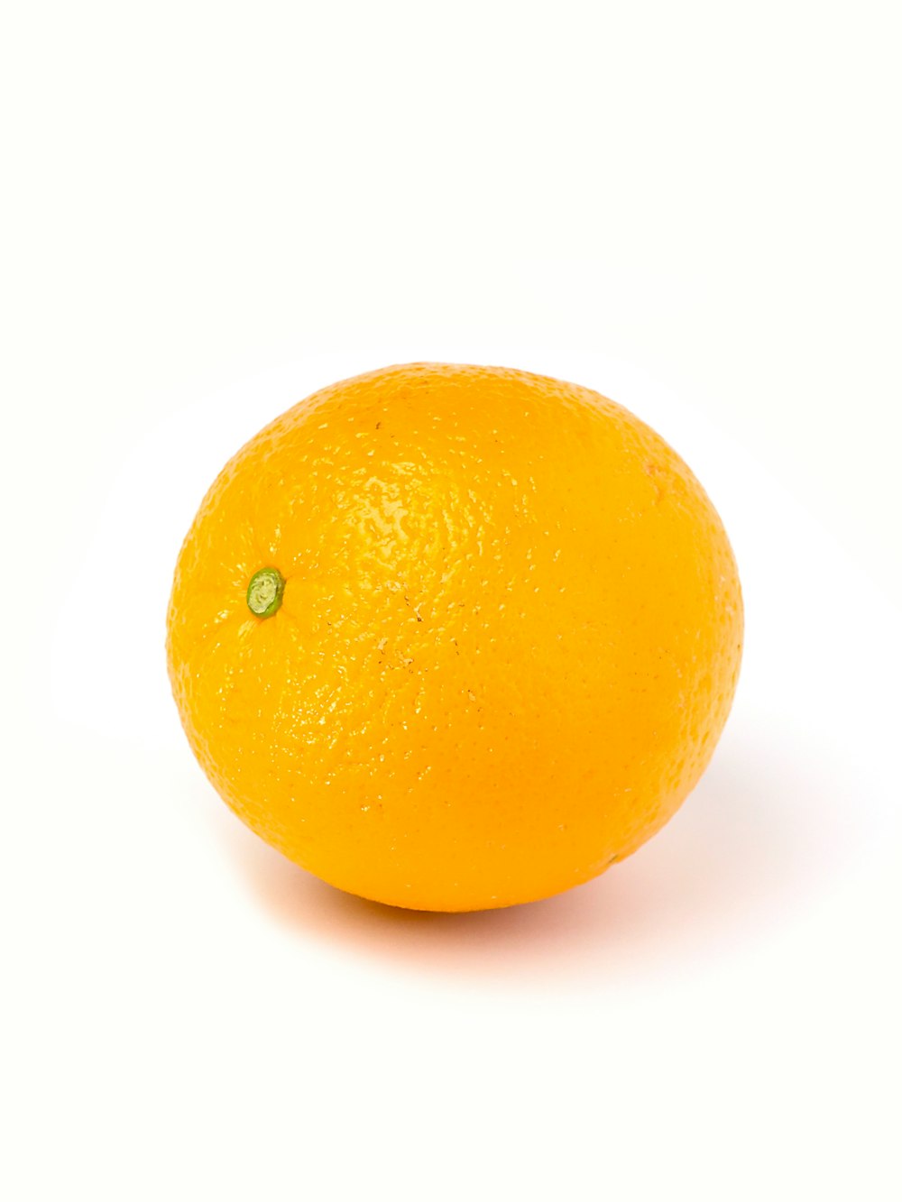 orange fruit on white surface