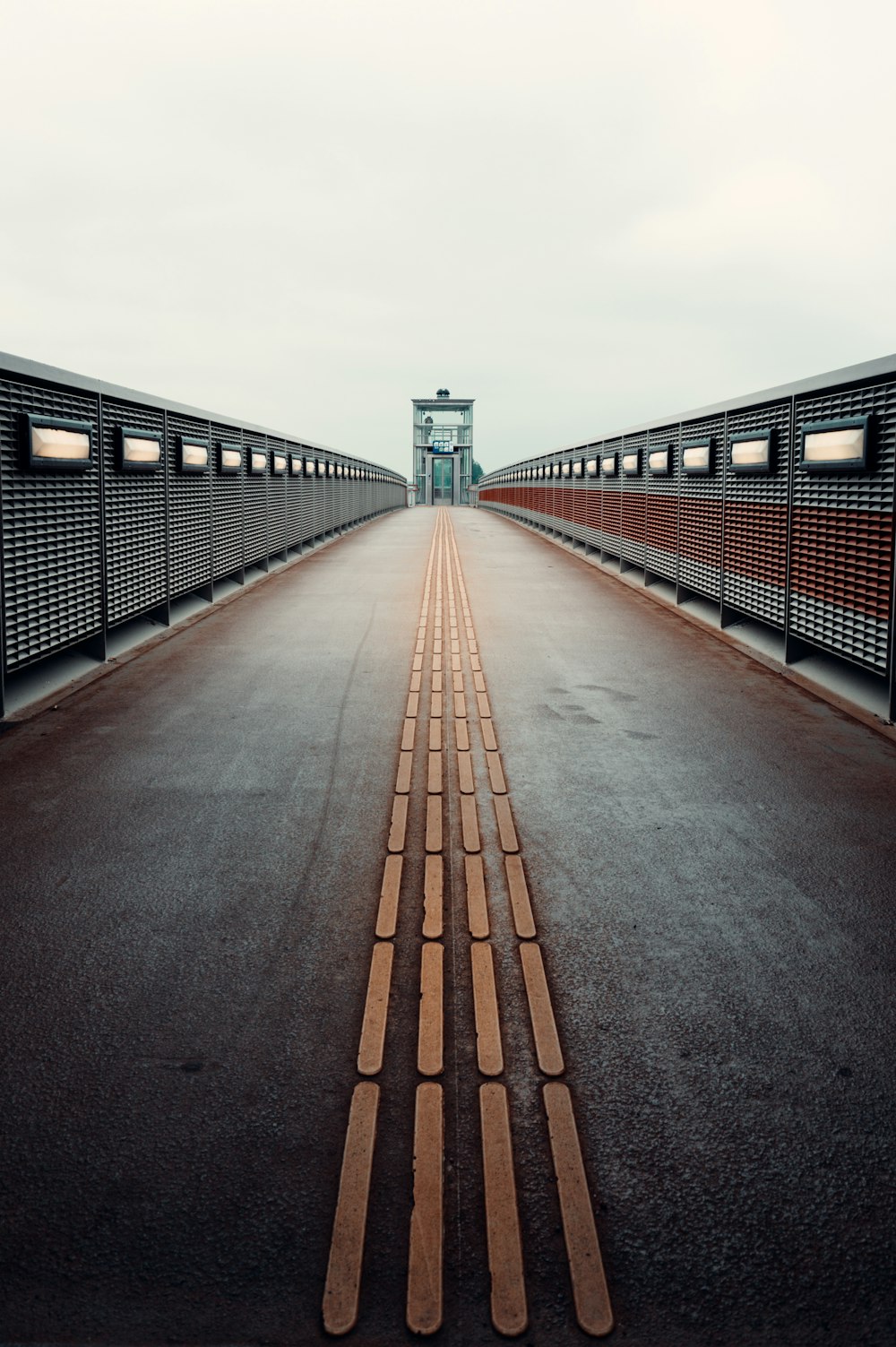 brown concrete bridge under white sky during daytime