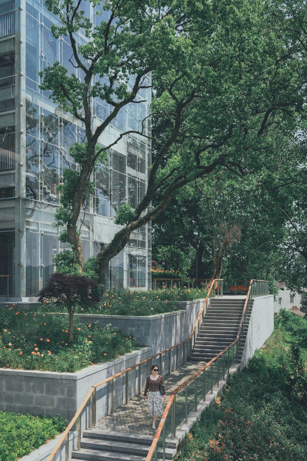 green trees near white concrete building during daytime