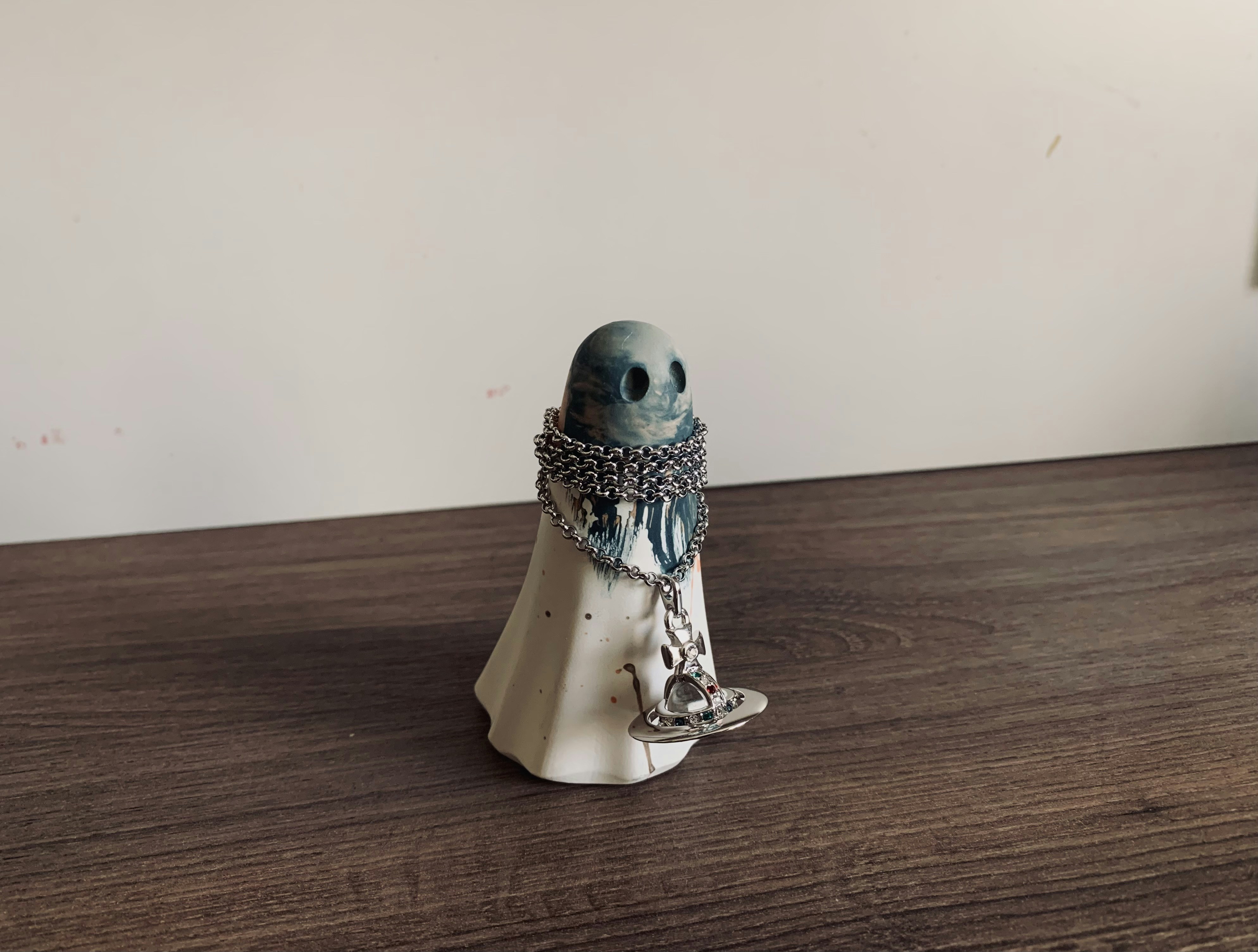 white and silver figurine on brown wooden table