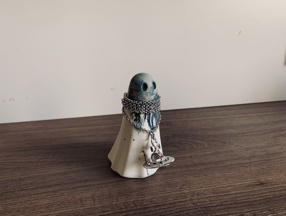 white and silver figurine on brown wooden table