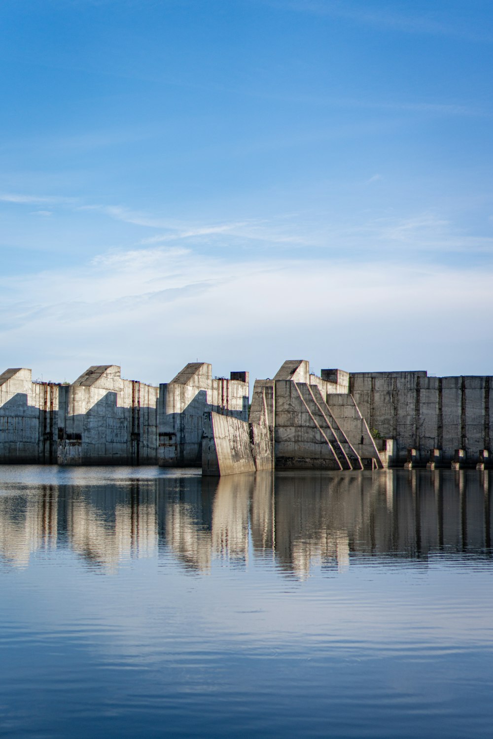 gray concrete building beside body of water during daytime