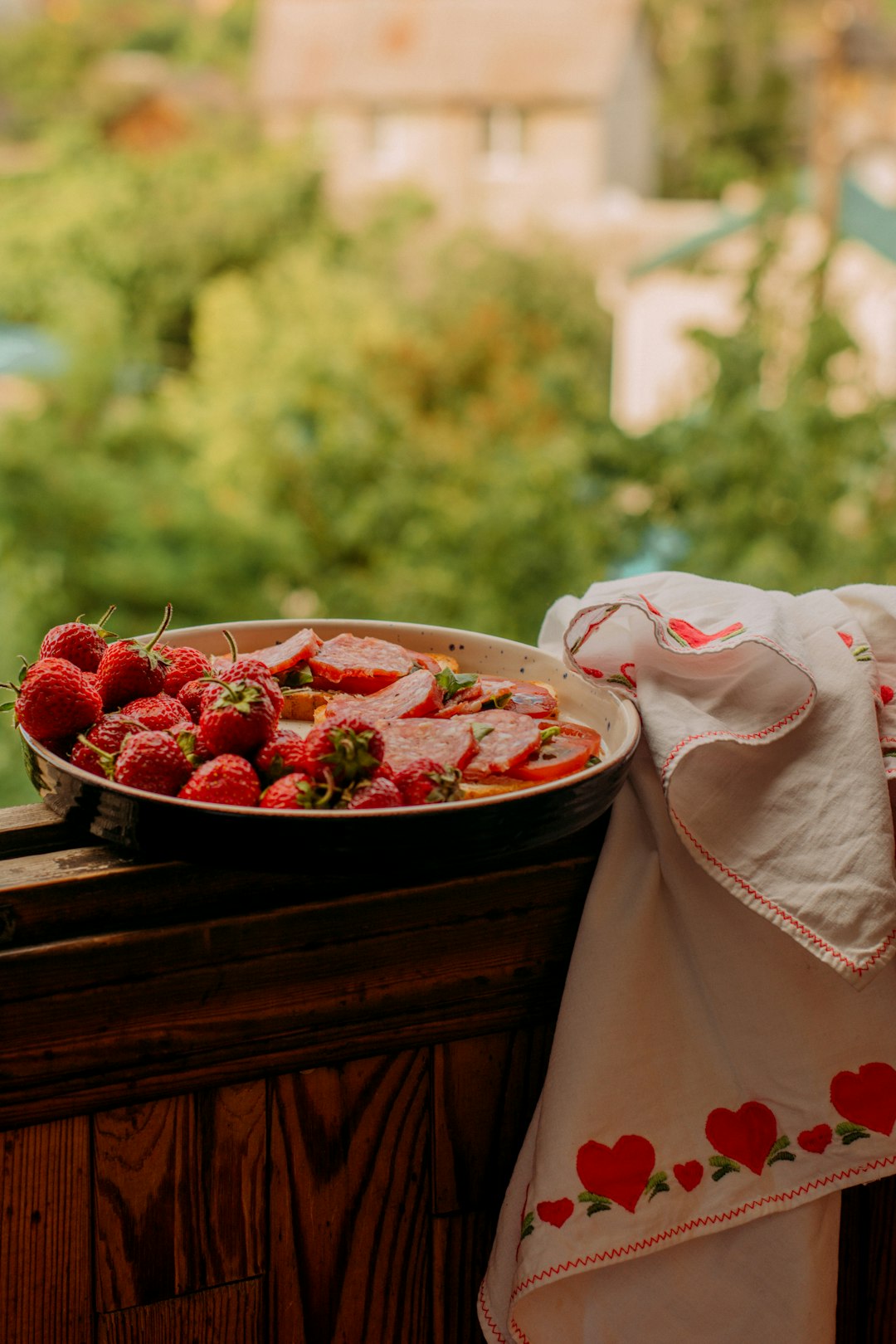 red strawberries in brown ceramic bowl