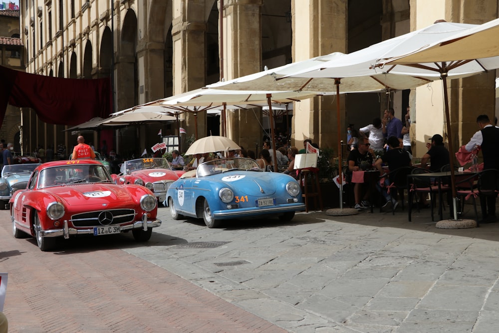 blue and red car on street during daytime