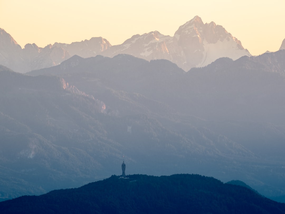 person standing on top of mountain during daytime