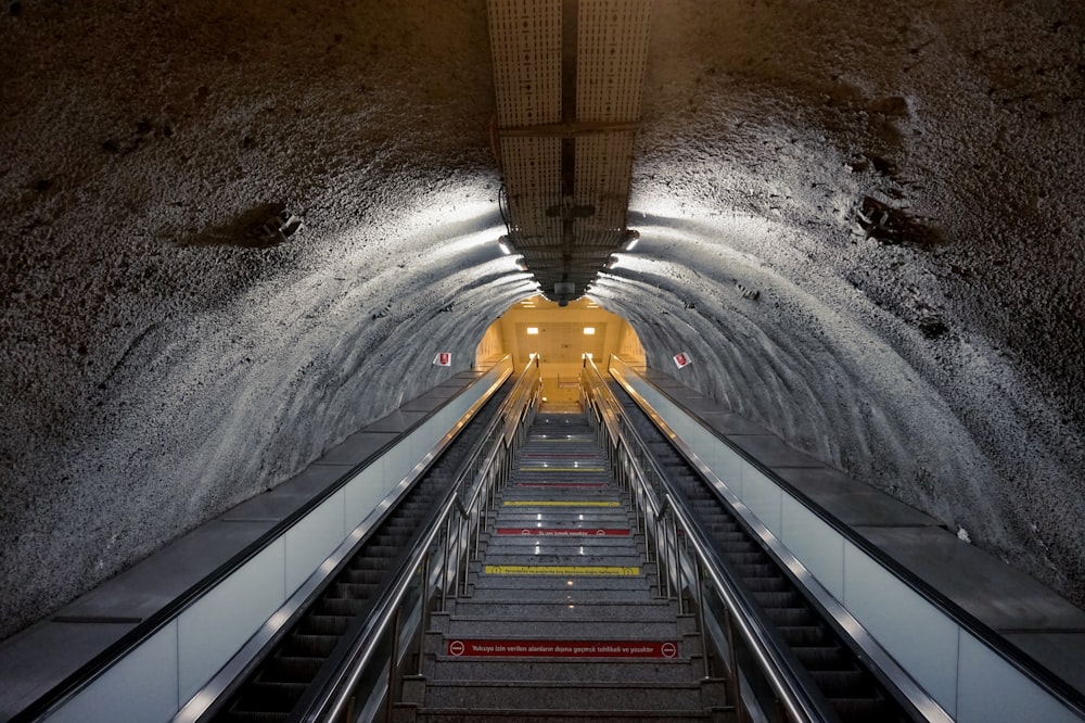 time lapse photography of water falling from tunnel