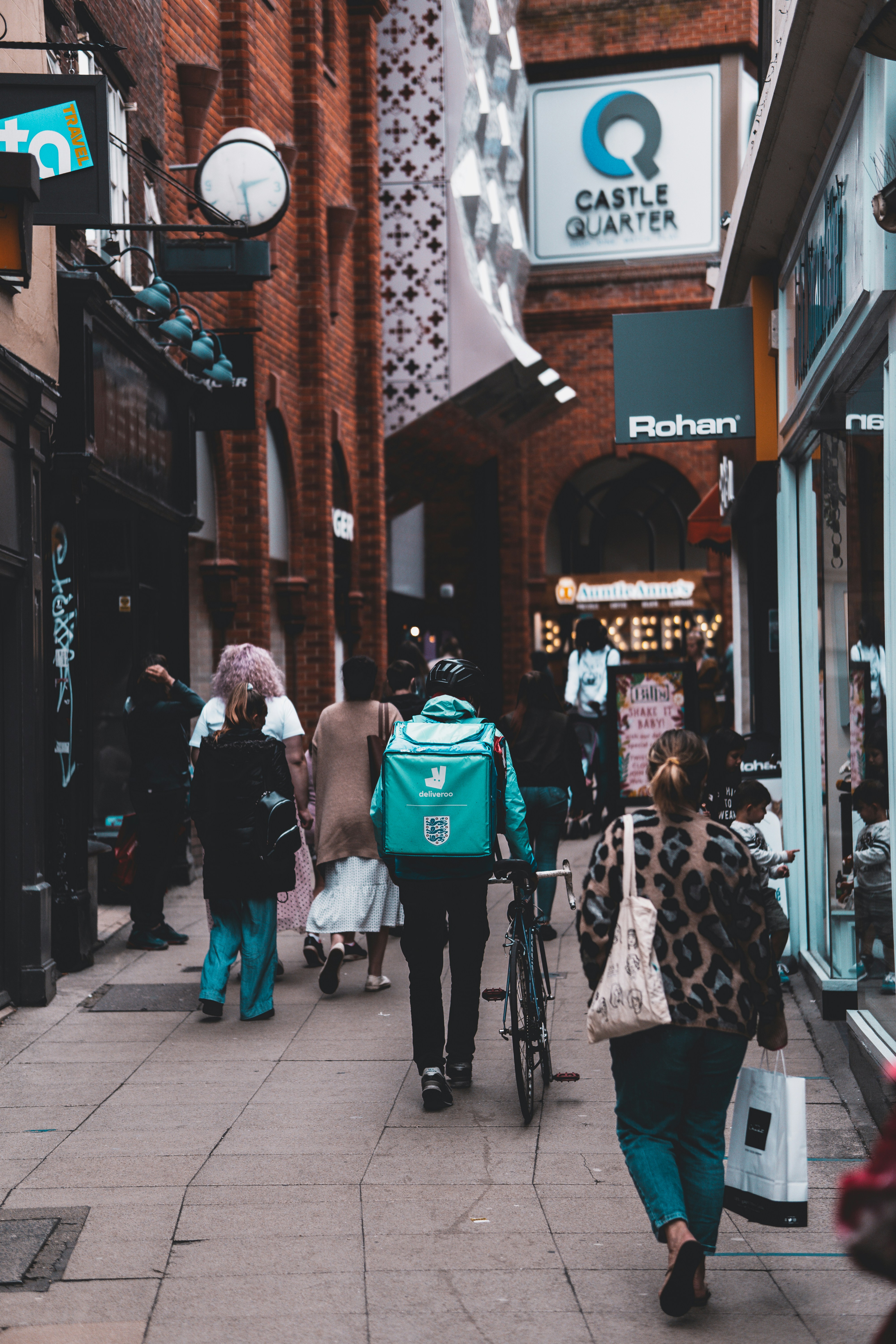 Deliveroo bicycle delivery rider in city centre.