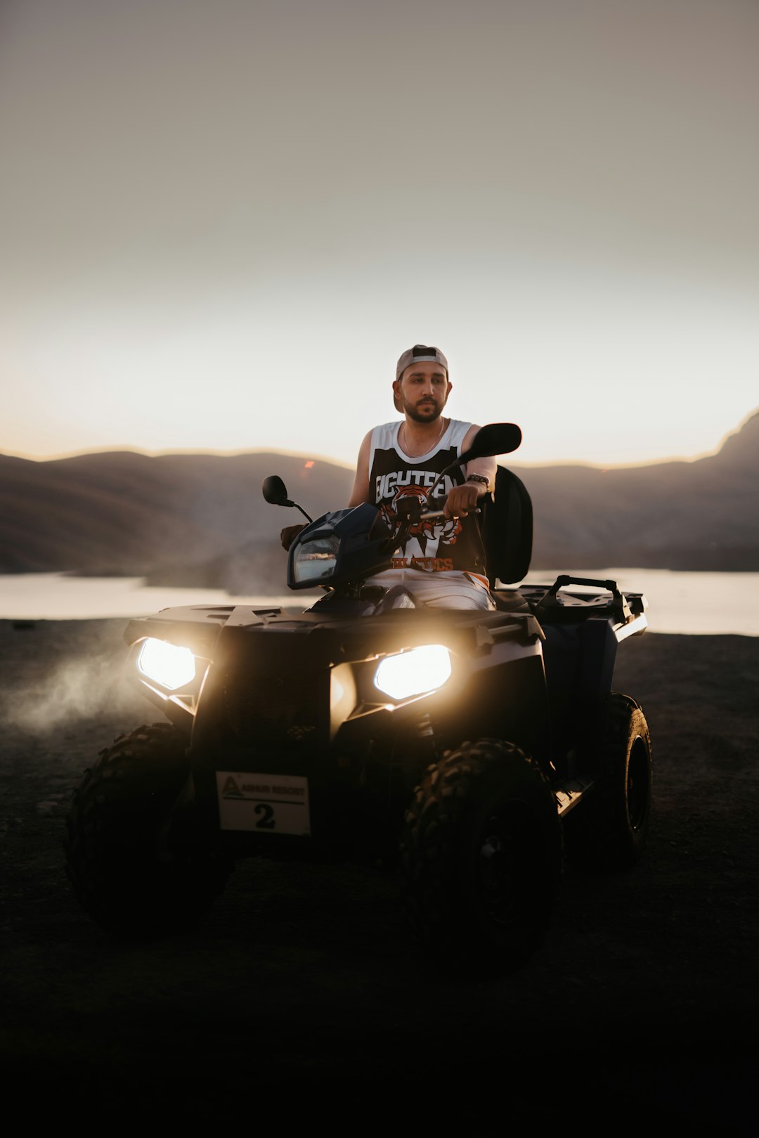 man in black and white crew neck t-shirt riding on black atv