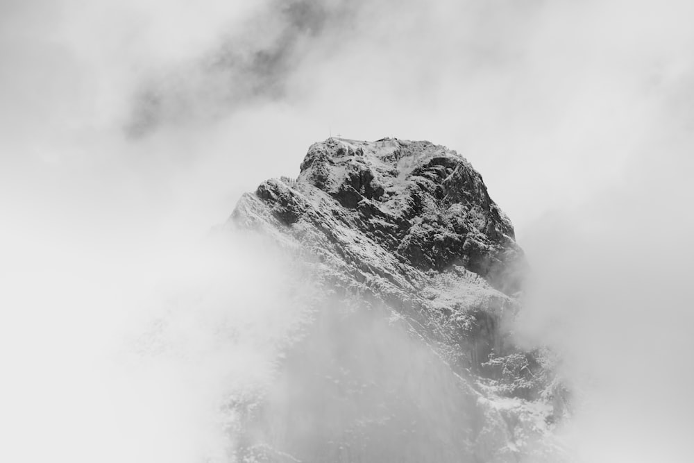 grayscale photo of rocky mountain covered with snow