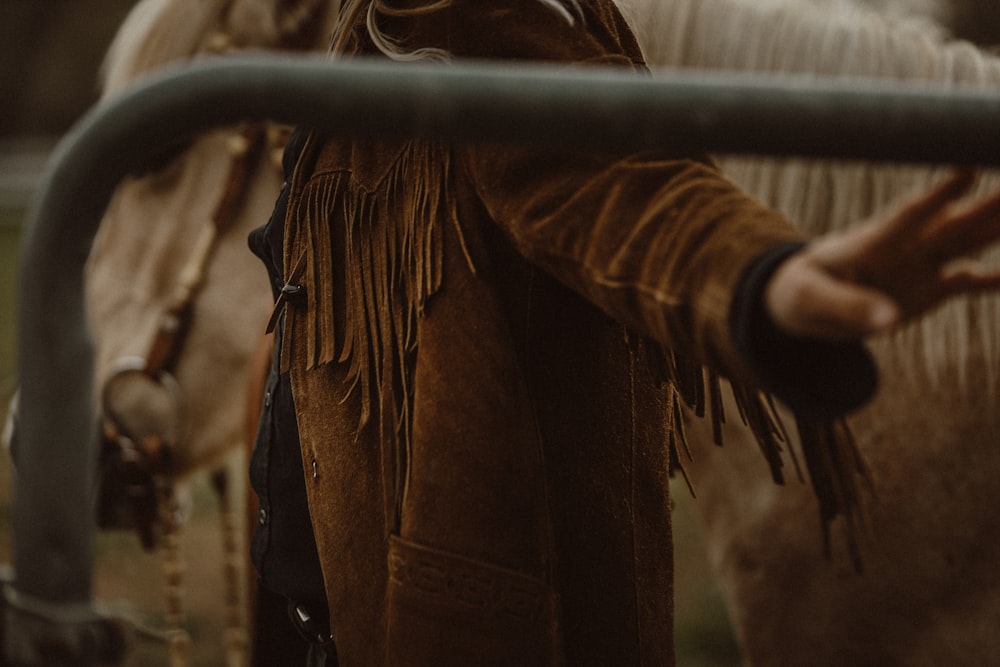 person in brown long sleeve shirt holding brown rope