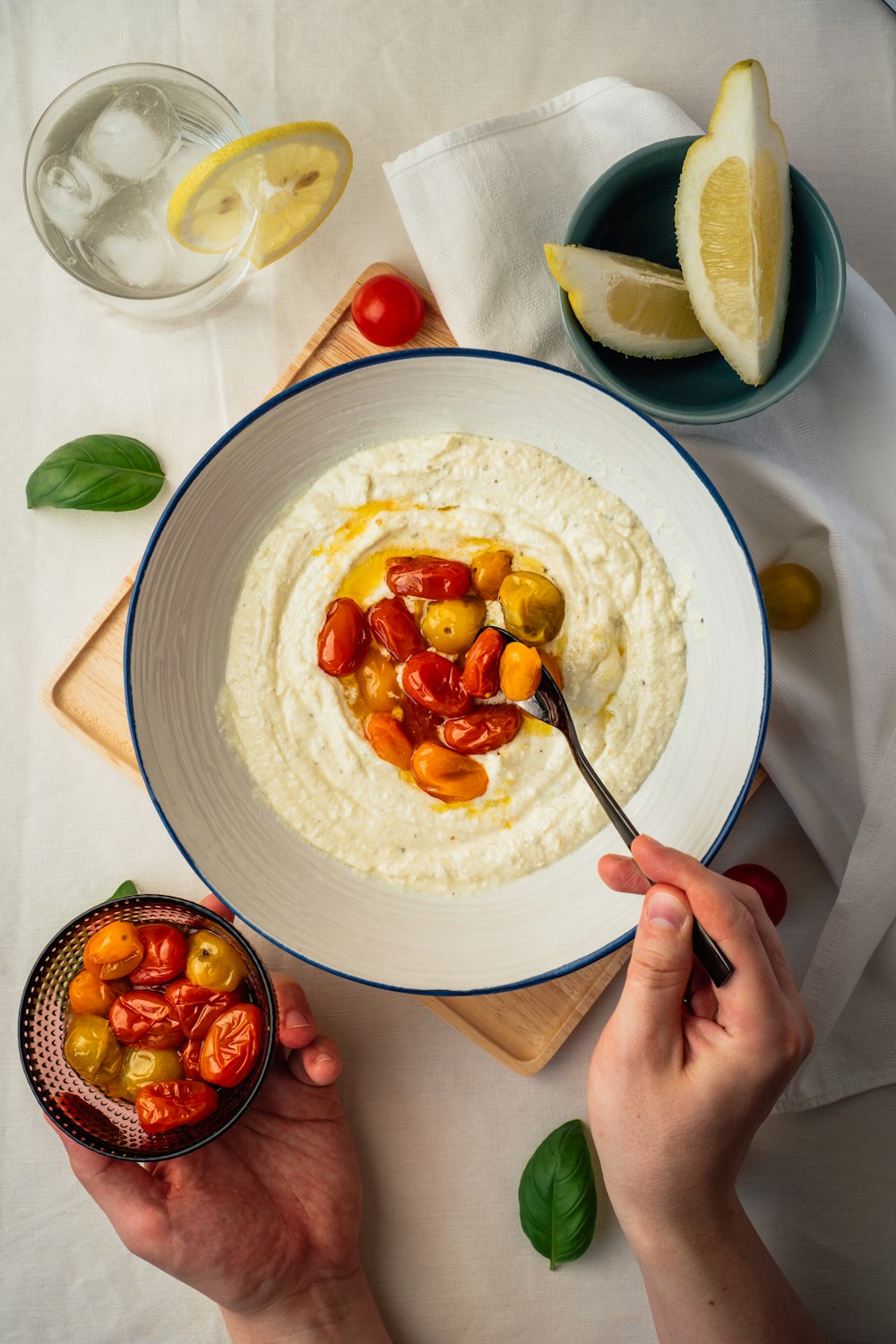 person holding stainless steel fork on white ceramic plate