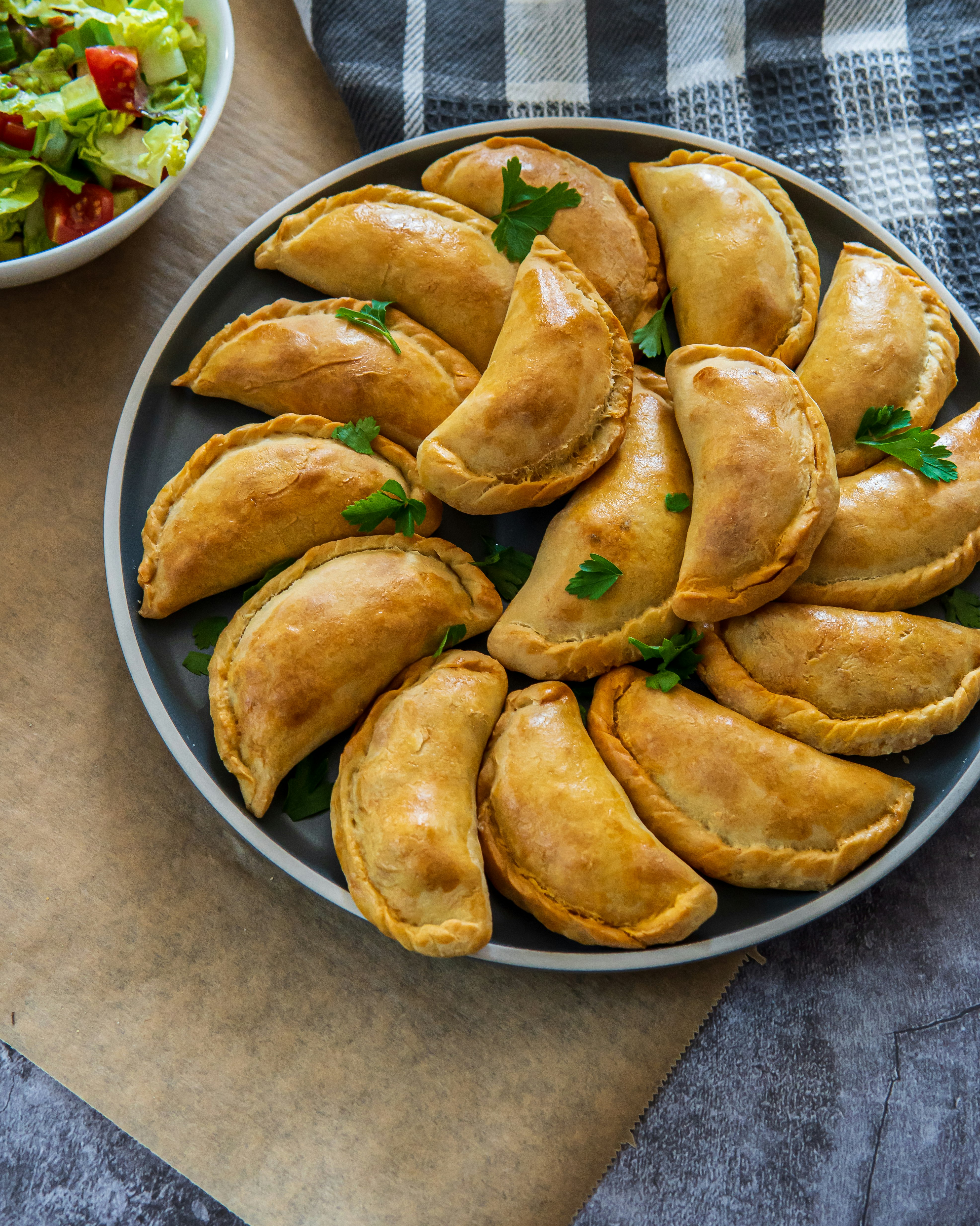 Traditional Latin American baked beef empanadas on a plate with a fresh salad side dish. Gluten free savory pastries with meat stuffing or filling. Handmade typical dish in Spain or Argentina. Top 🥟➡️

Hey 👋, Thanks for visiting! Donations help & motivate me to keep uploading more 📸's and 🎥’s. Even a buck or two helps (or a cup of coffee ☕). Thank you