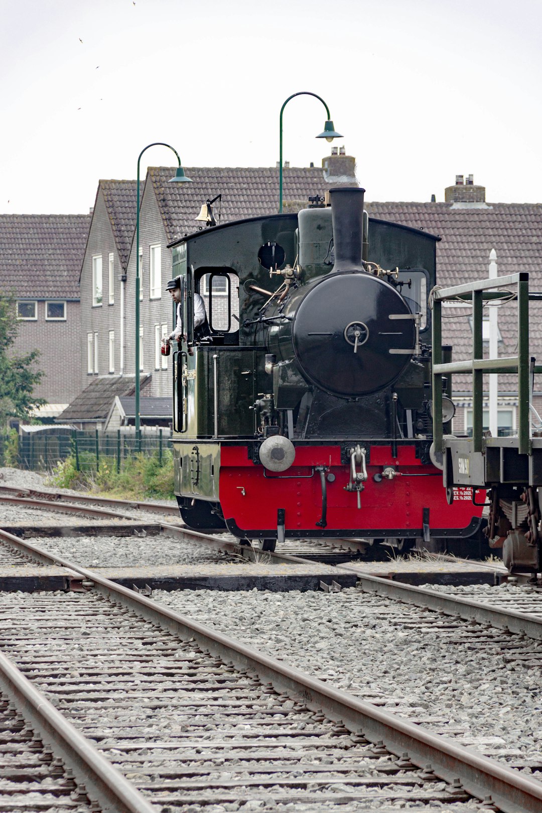 red and black train on rail tracks during daytime