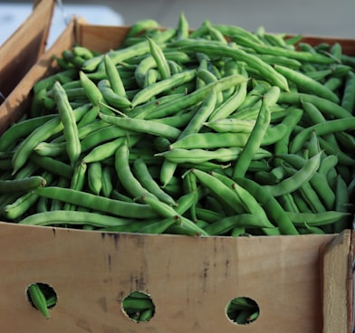 green string beans on brown wooden crate