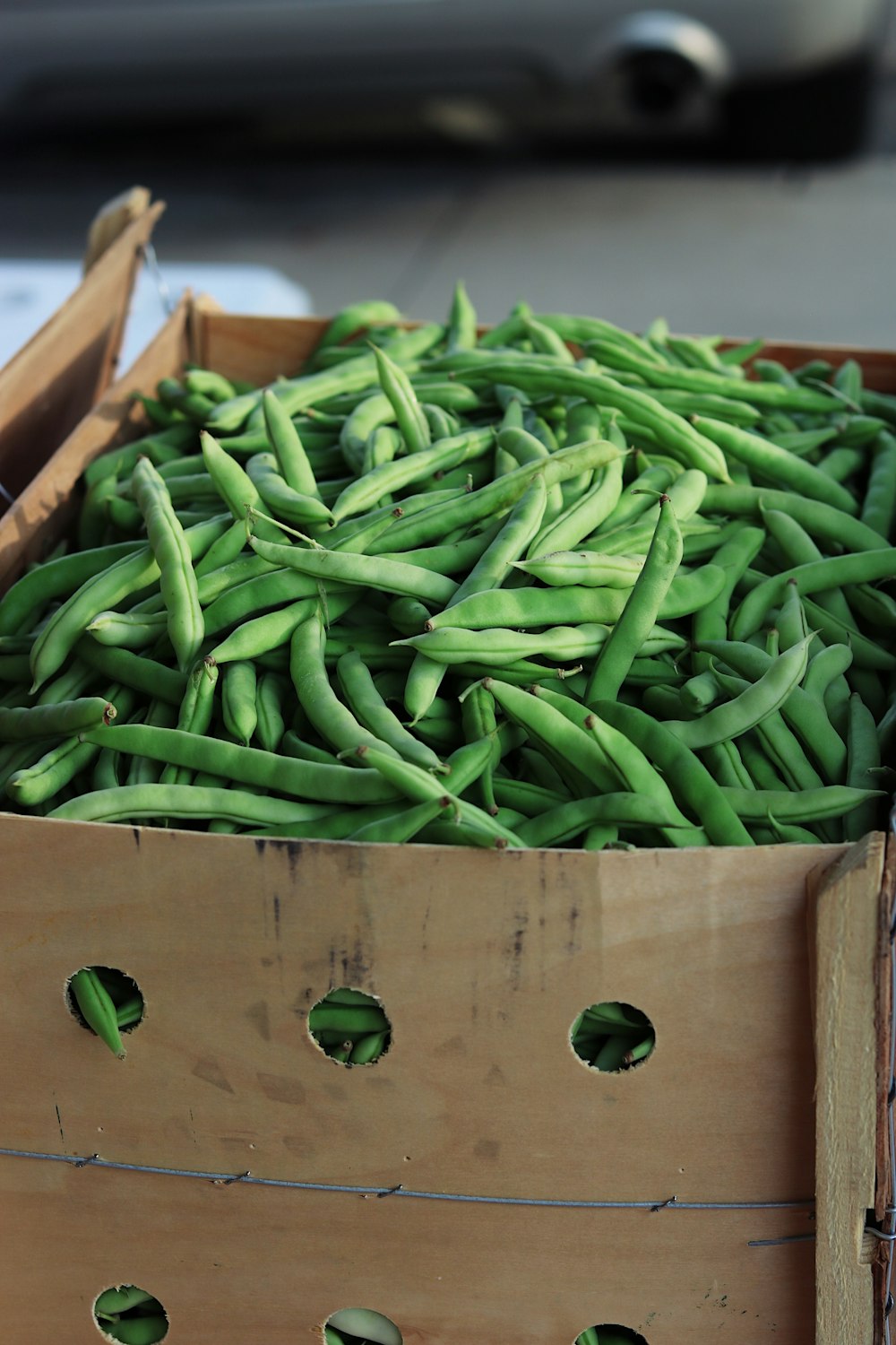 green string beans on brown wooden crate