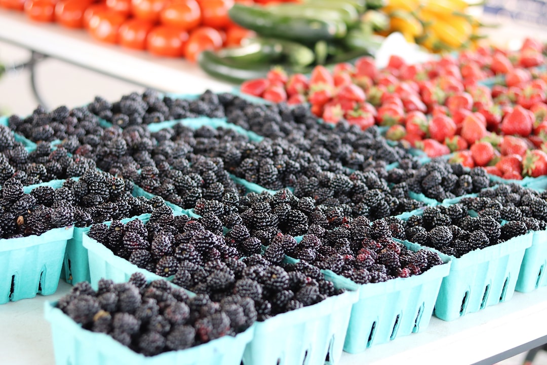 red and black berries in white plastic crate