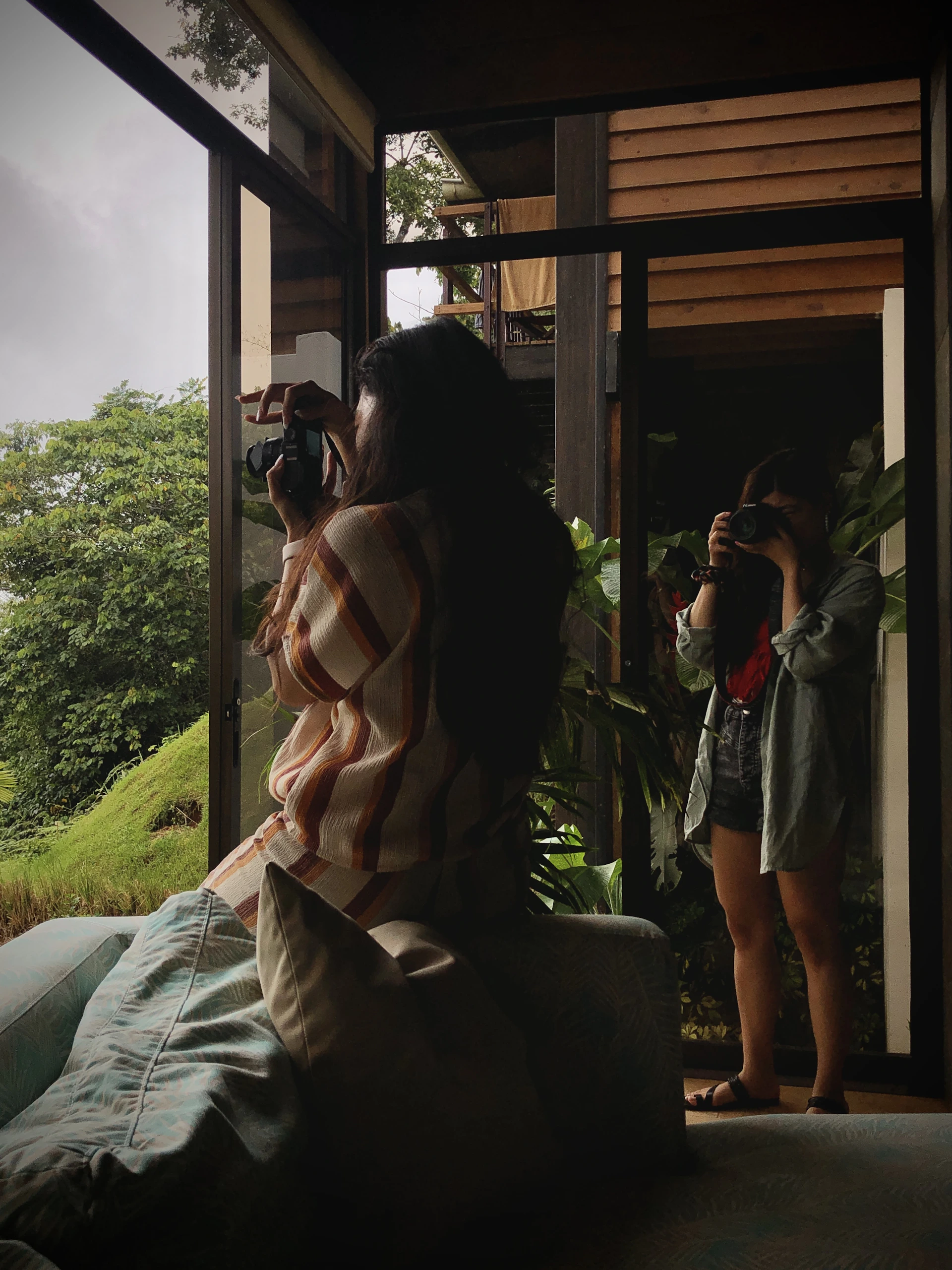 A cozy moment inside their minimalist travel studio, with cameras and notebooks scattered as they plan their next adventure.
