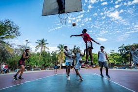 people playing basketball during daytime