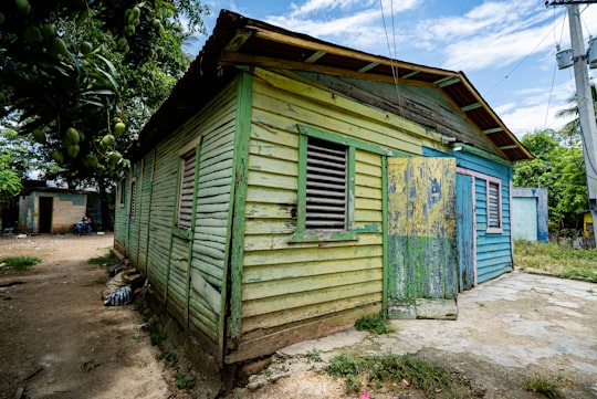 blue and white wooden house near green trees during daytime in Villa Mella Dominican Republic