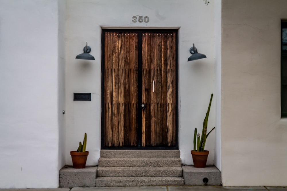 brown wooden door on white concrete wall