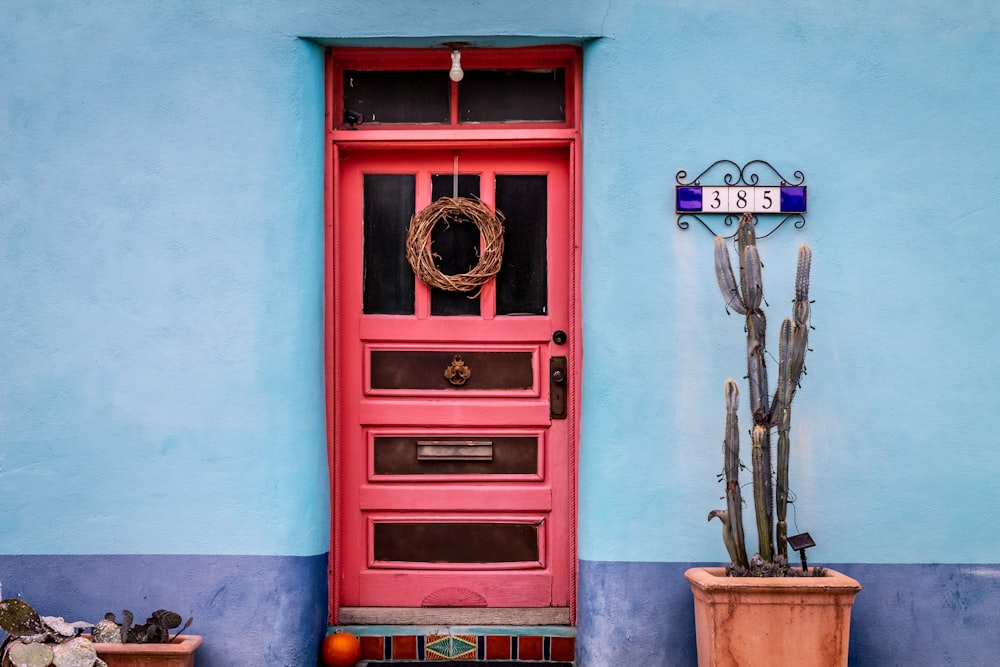 red wooden door with brass door knob