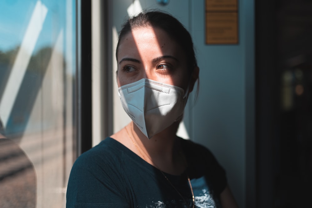 woman in black crew neck shirt wearing white face mask