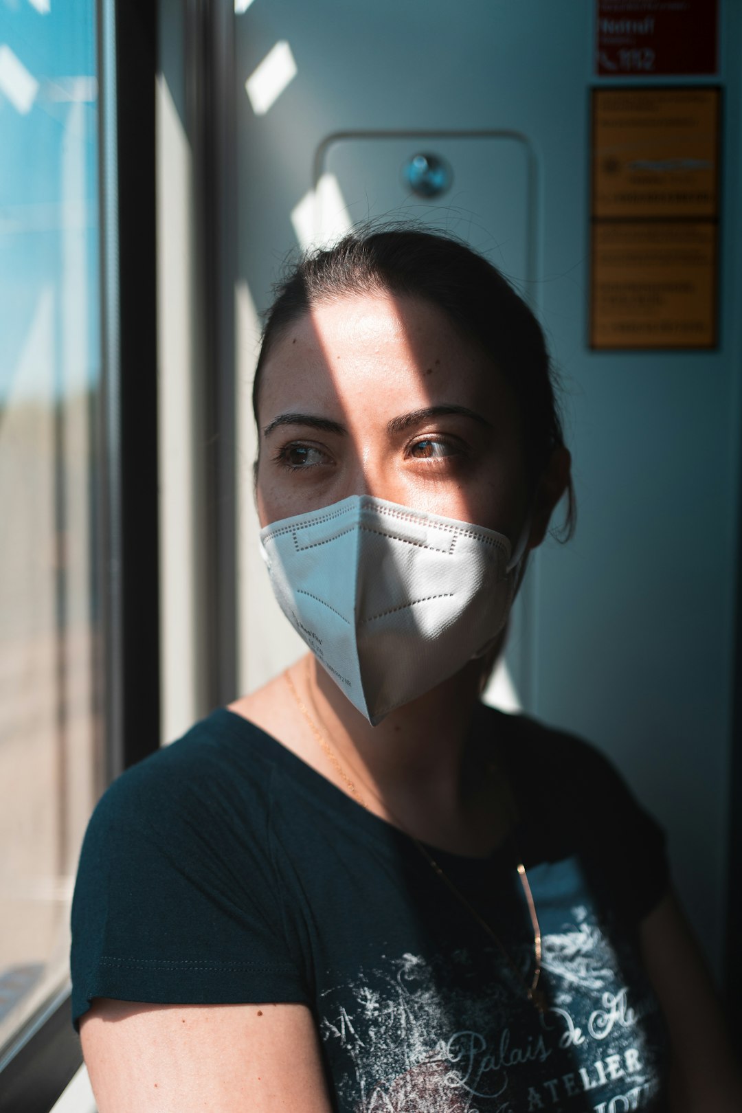 woman in black crew neck shirt wearing white face mask