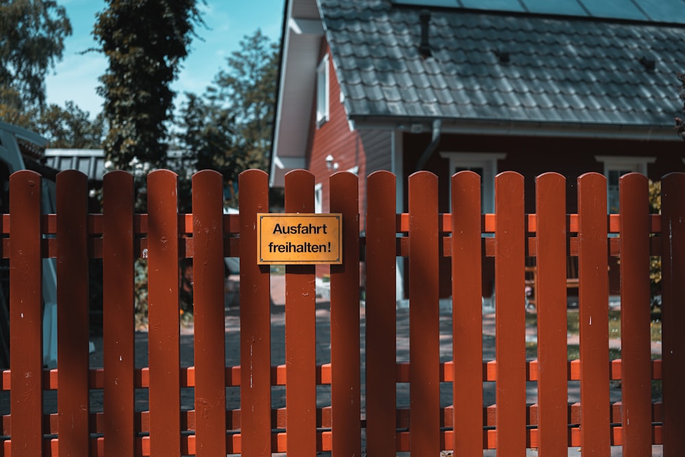 red wooden fence with no smoking sign