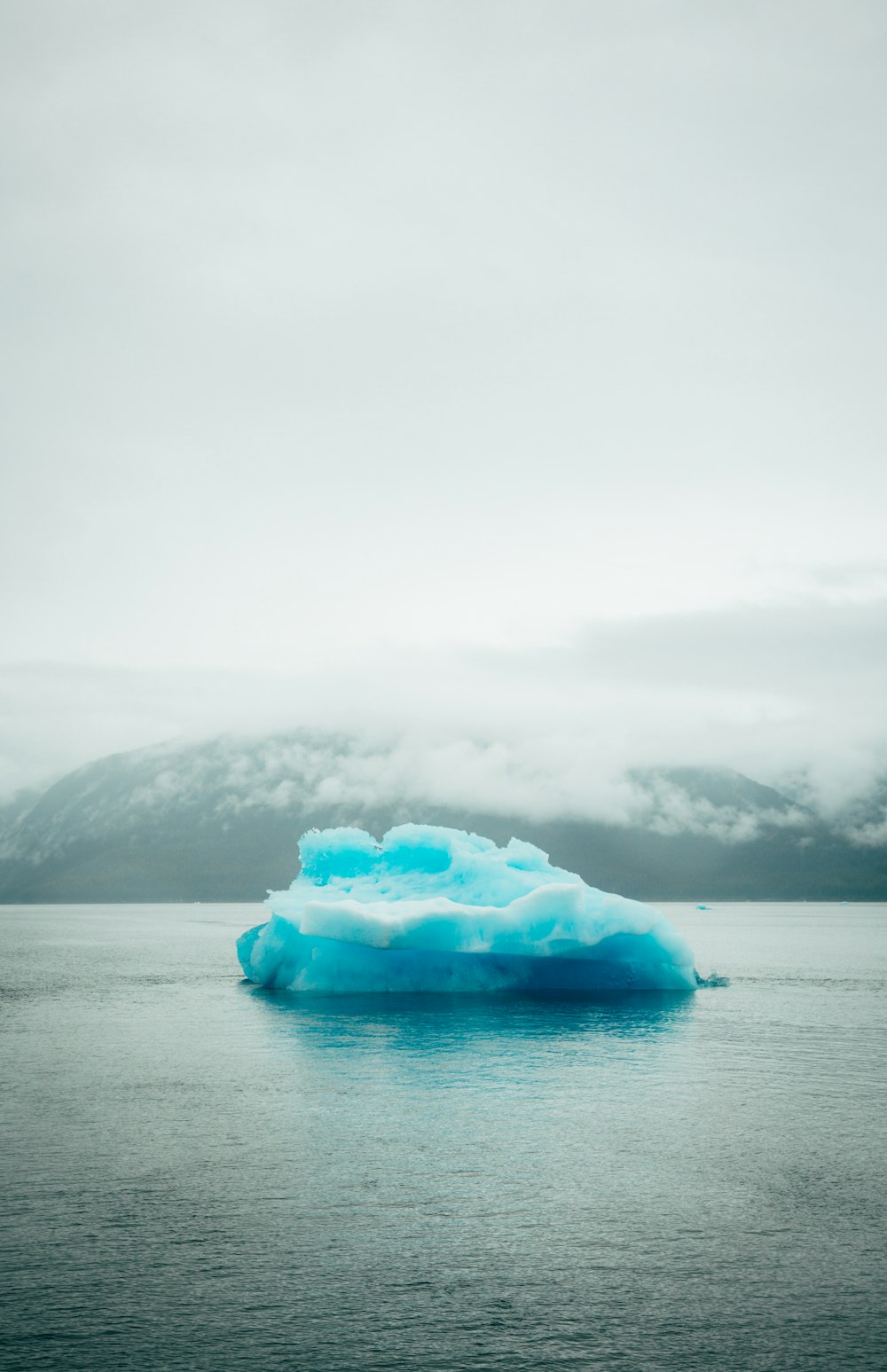 blue ice on body of water during daytime