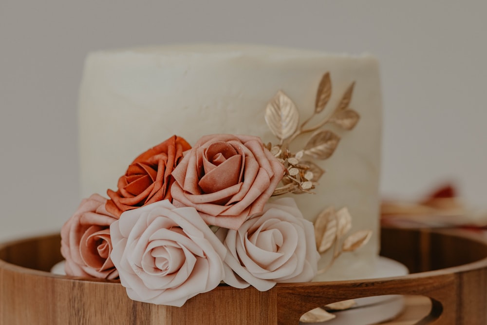 pink roses on white ceramic vase