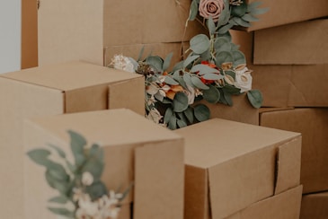 brown cardboard box with green and red flowers