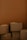 A stack of cardboard boxes against a brown background. The boxes are in various sizes and are closed, some slightly worn, giving a sense of storage or moving.