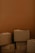 A stack of cardboard boxes against a brown background. The boxes are in various sizes and are closed, some slightly worn, giving a sense of storage or moving.