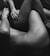 The black and white photo features two intertwined human bodies, focusing on their limbs and torsos. The composition emphasizes intimacy and connection through close physical contact.