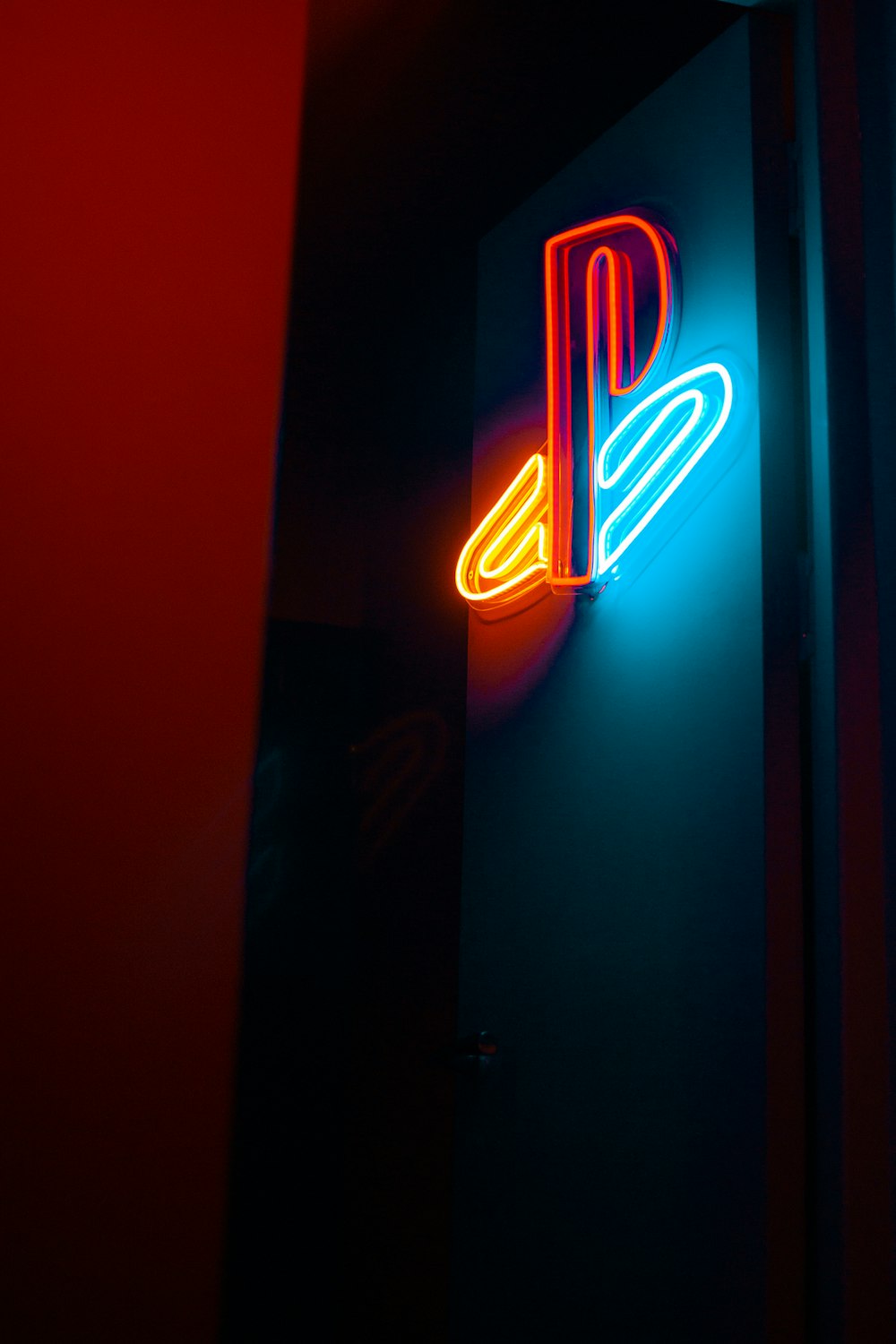 a neon sign that is on the side of a wall