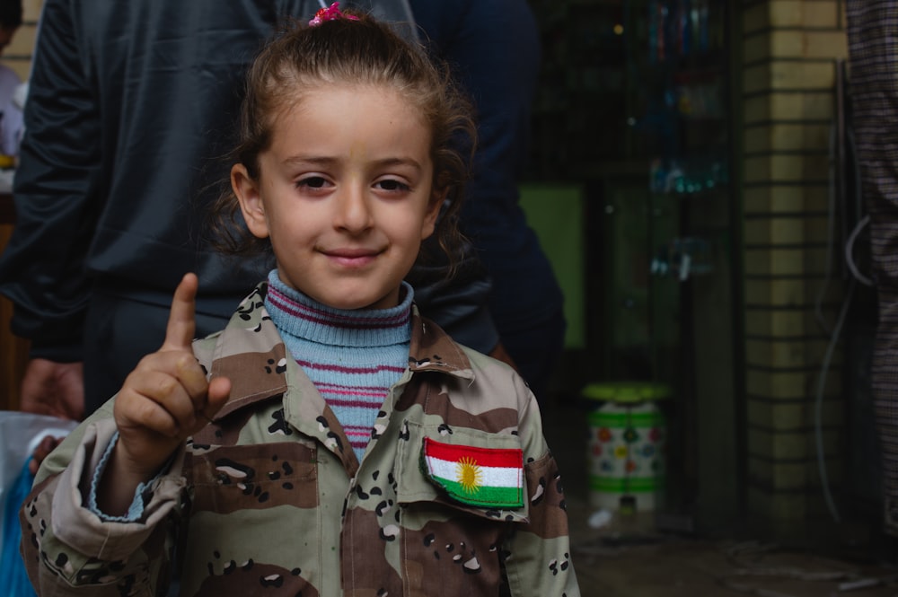 boy in green and brown camouflage jacket