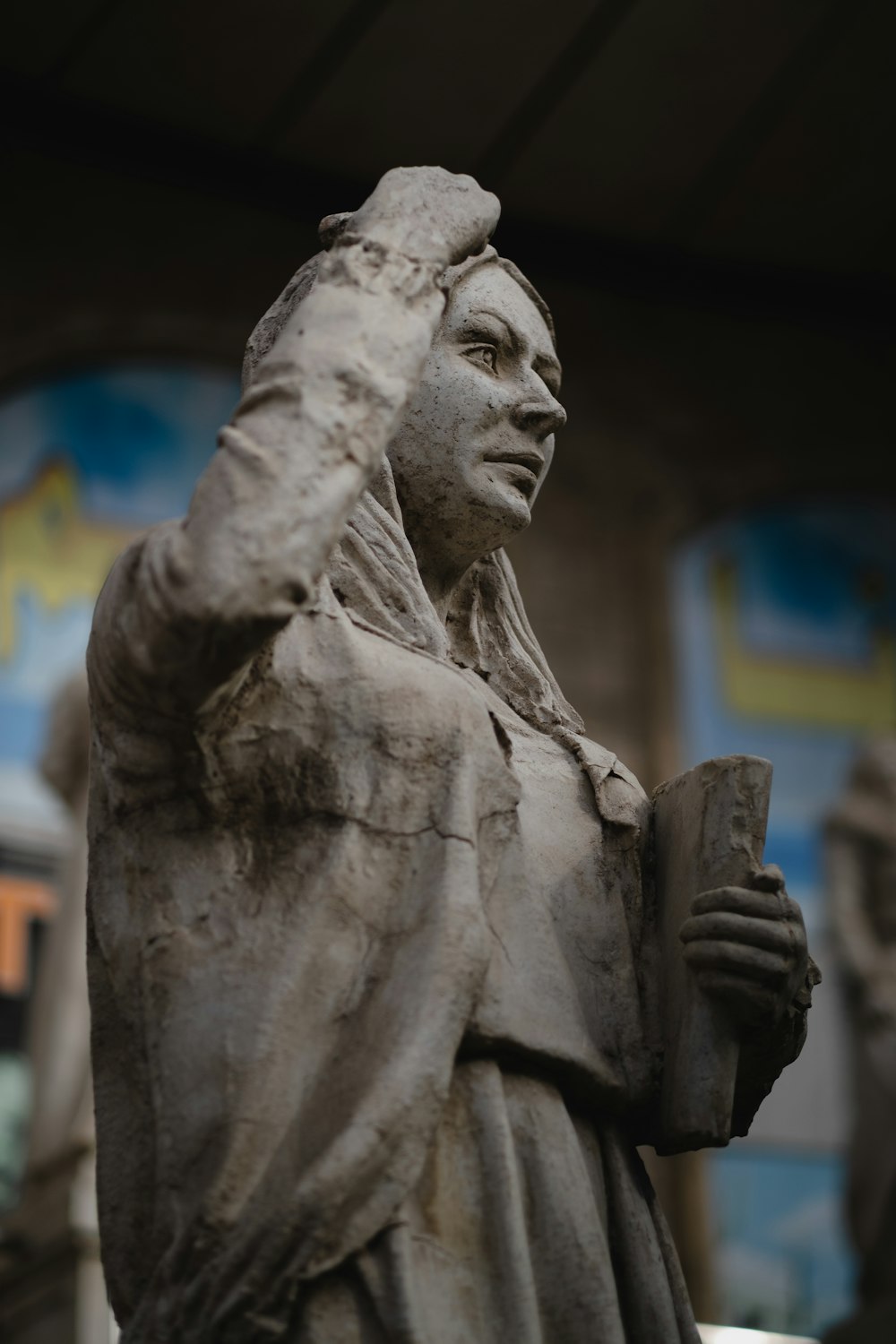 man holding a cup statue