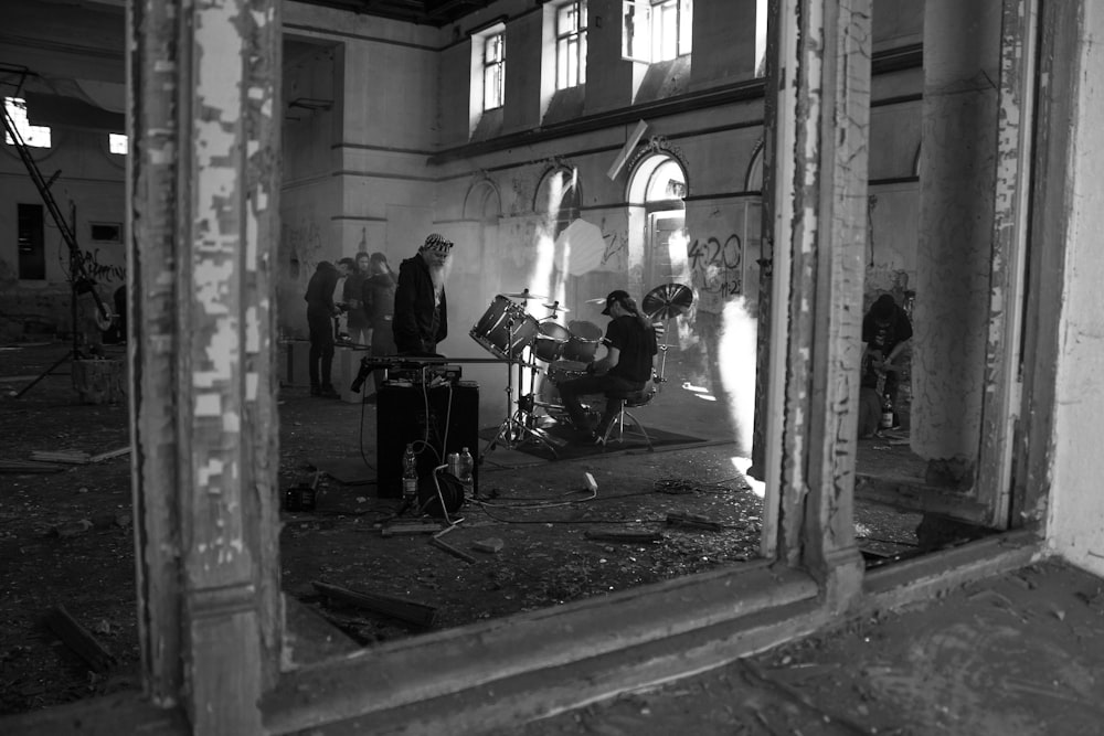 grayscale photo of people sitting on chairs