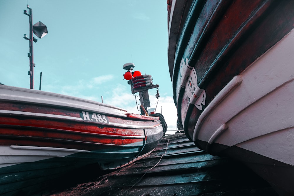 red and white boat on dock during daytime