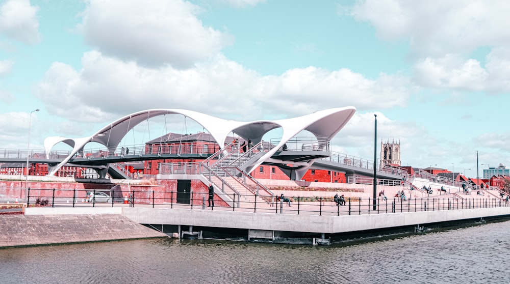 white and red stadium near body of water during daytime